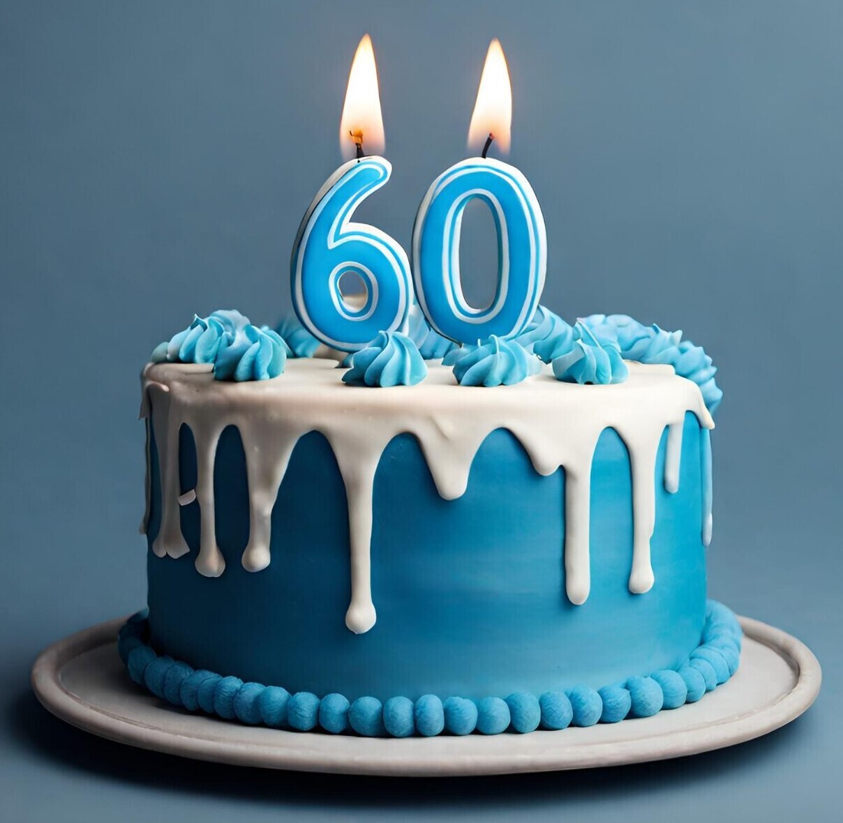 Blue birthday cake with lit candles on top in the shape of a six and a zero